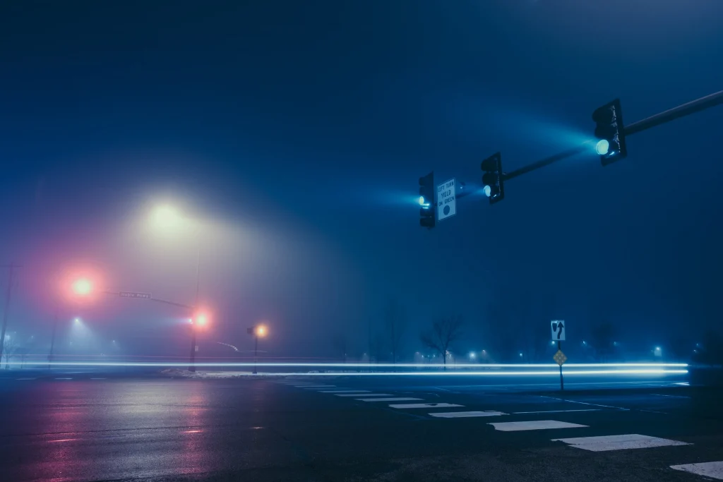 Night street photography featuring a foggy scene.