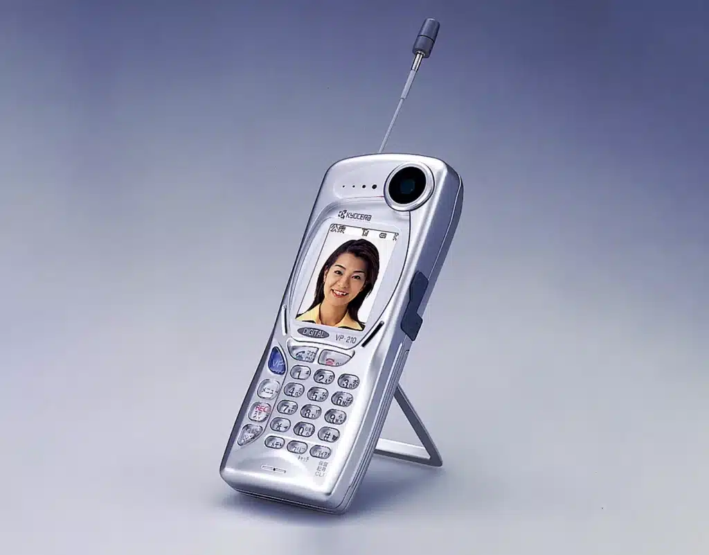 A cell phone with a picture of a woman on it, symbolizing the advent of camera technology.