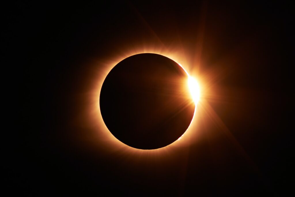A solar eclipse is seen in the dark sky, providing an opportunity to practice how to photograph the moon.