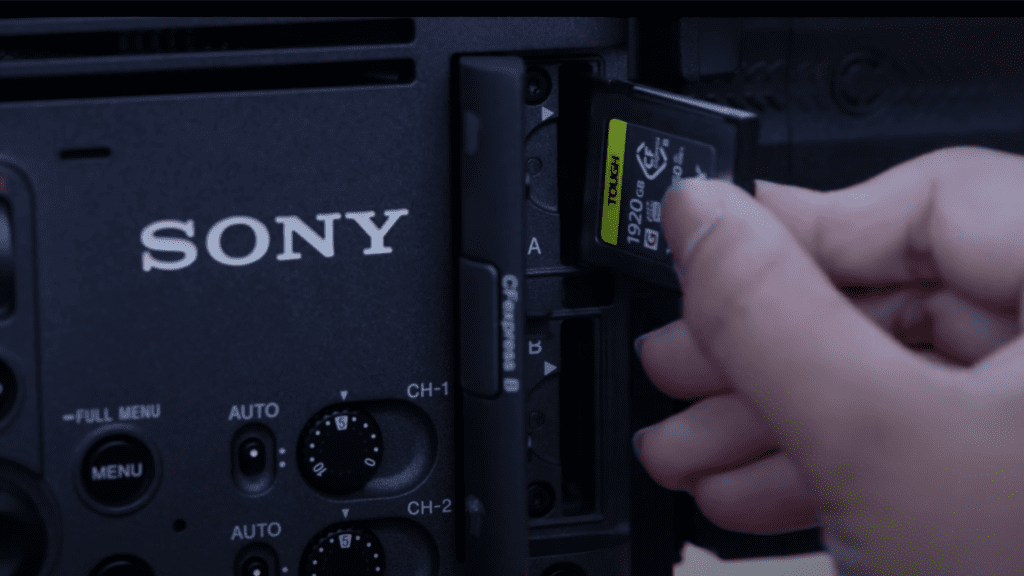 A person inserting a sd card into a sony camera.