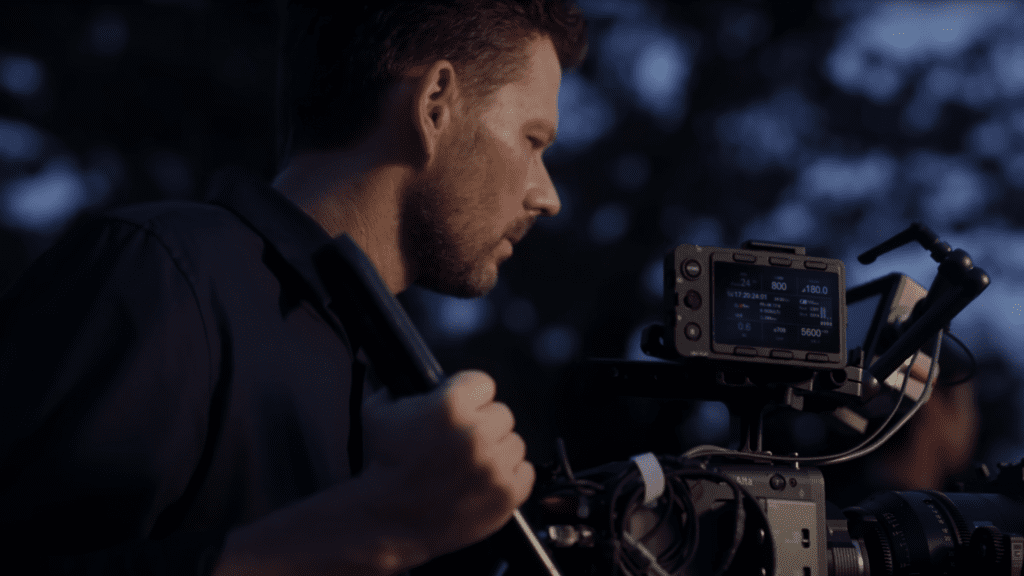 A man is using a camera to film a movie.