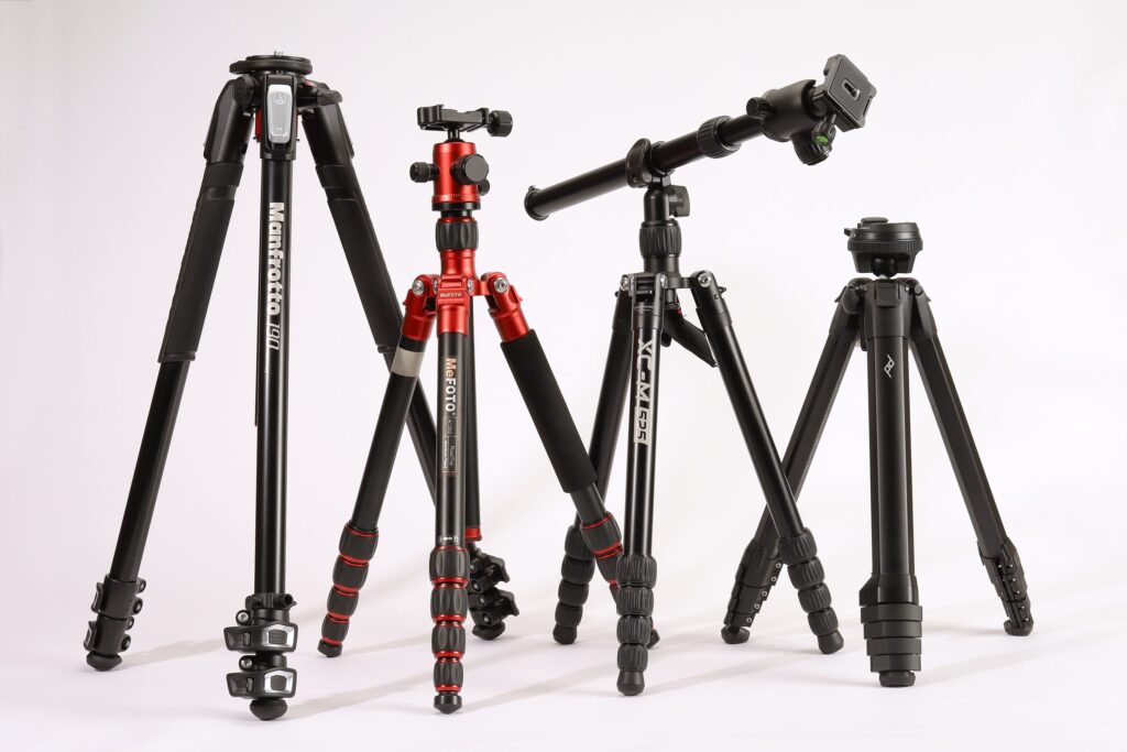 Four tripods on a white background with different types.