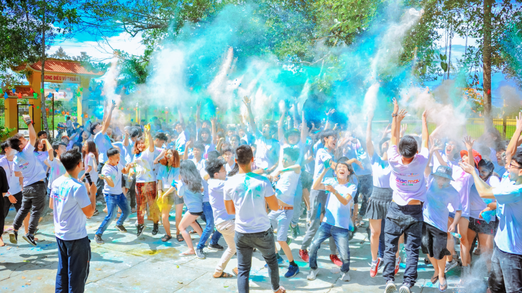 Event Photography Pricing: A group of people joyfully throwing colored powder in the air.