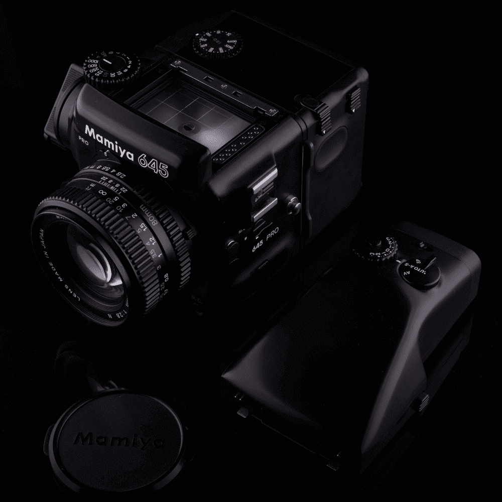 A Mamiya 645 Pro camera with a black body and a lens attached to it.