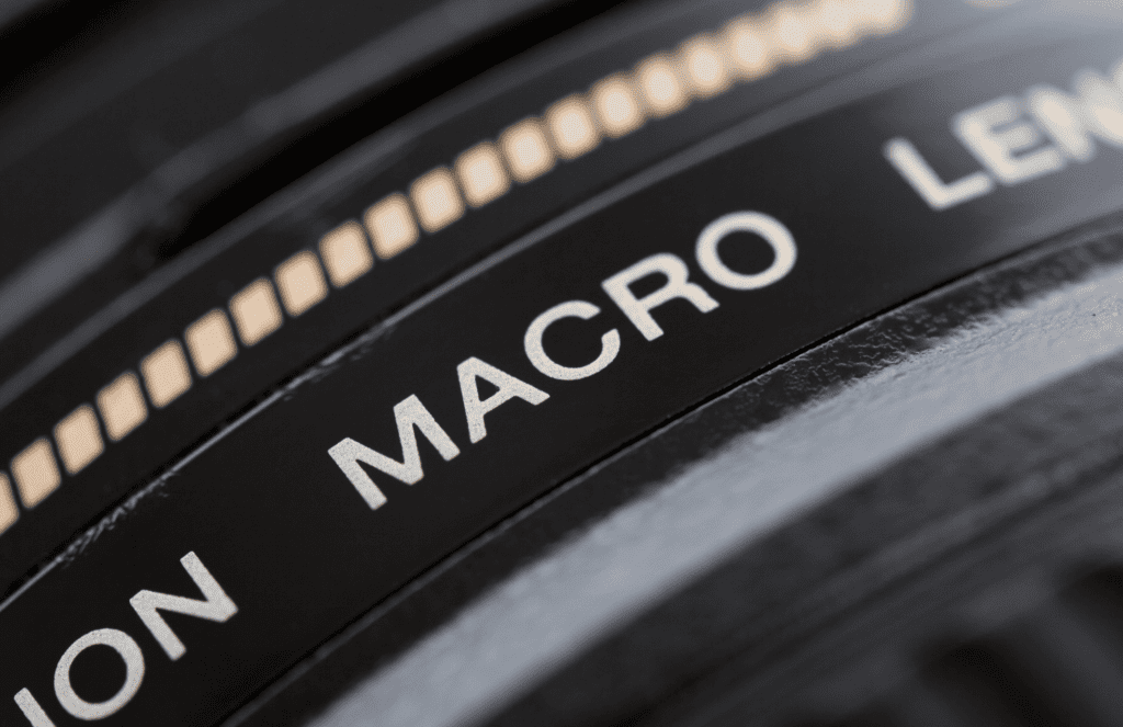Close-up of a camera lens with "macro" label for flower photography.