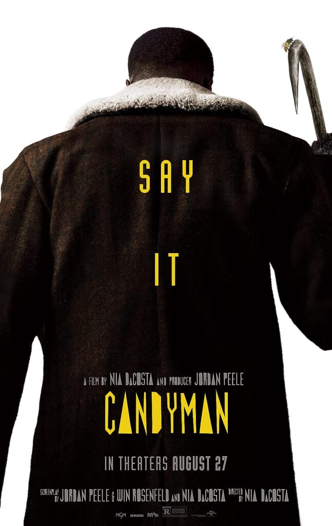 Poster for the film "Candyman" shows a person in a dark coat holding a hook. Text reads: "Say It," "A film by Nia DaCosta and producer Jordan Peele," and "In theaters August 27.