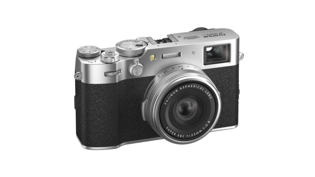 A silver and black compact digital camera with a lens and viewfinder, featuring various control dials and buttons.