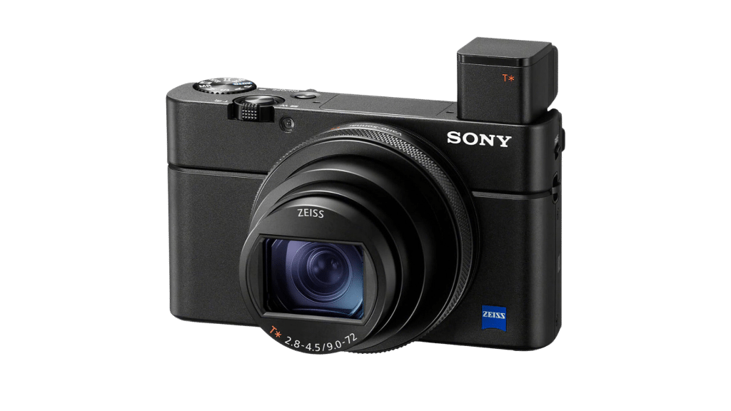 Black Sony digital camera with an extended lens and pop-up viewfinder, featuring Zeiss branding on the lens.